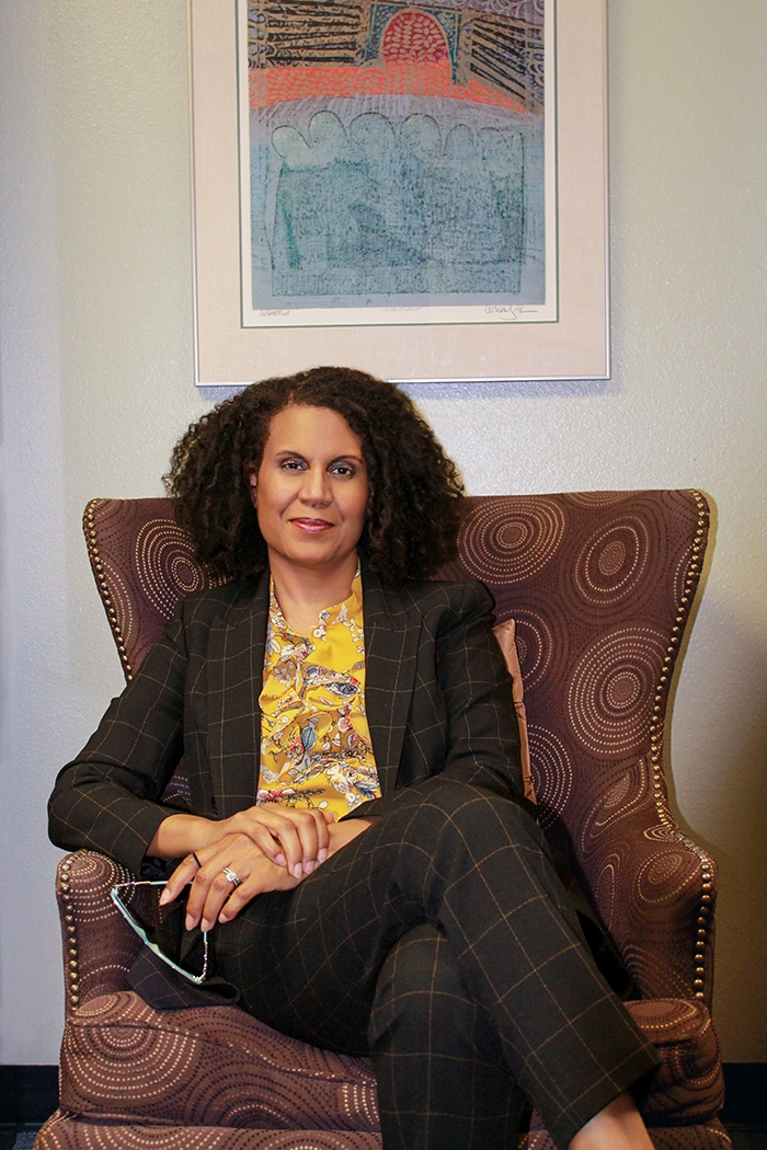 Dr. Lori Barker sitting on chair, facing the camera.
